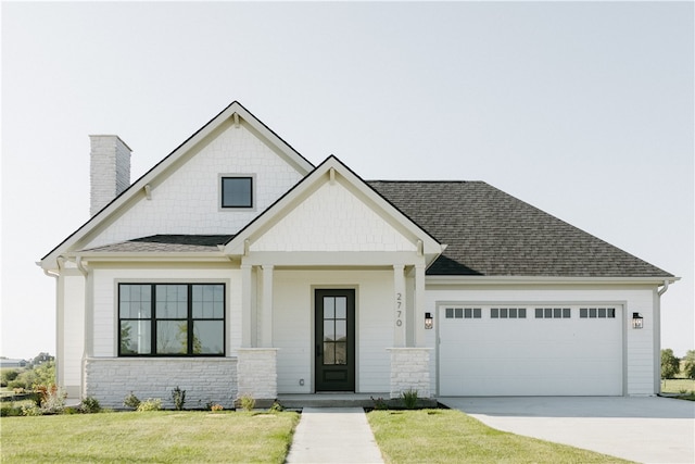 view of front of house with a garage and a front lawn