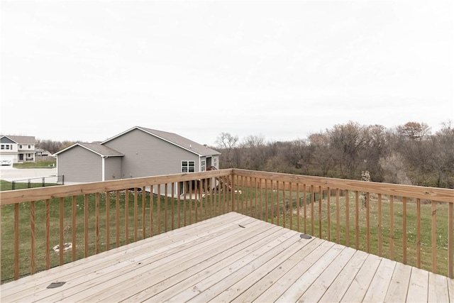 wooden terrace featuring a yard