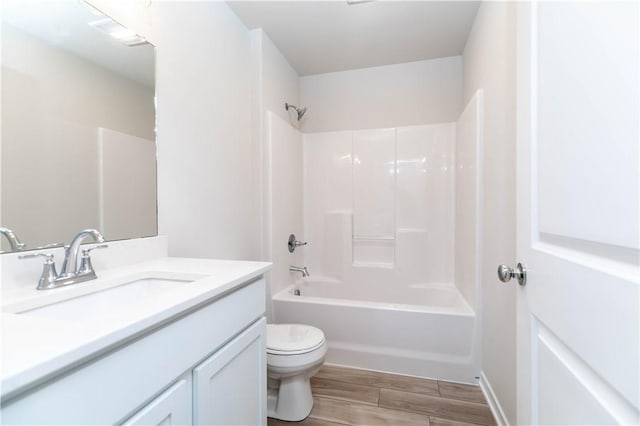 full bathroom featuring vanity, toilet, wood-type flooring, and bathtub / shower combination