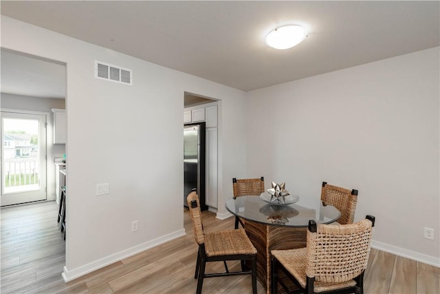 dining area featuring light wood-type flooring