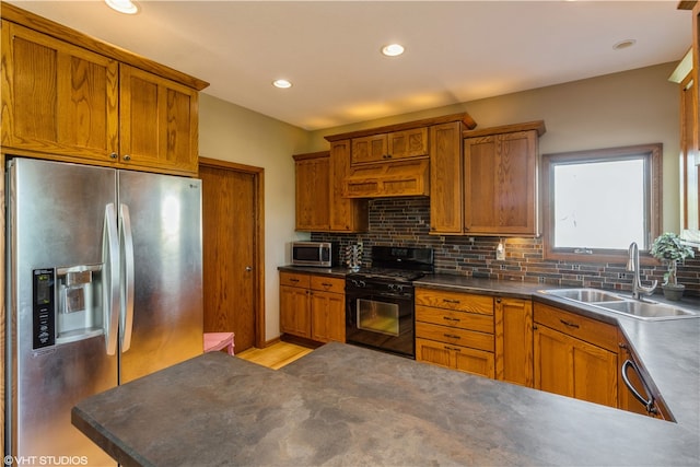 kitchen with backsplash, appliances with stainless steel finishes, sink, light hardwood / wood-style flooring, and custom range hood