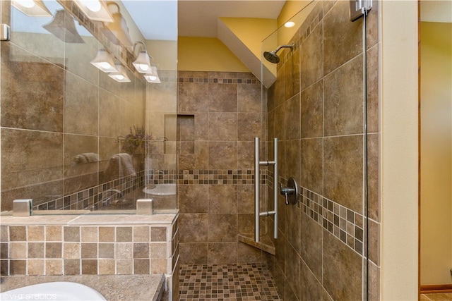 bathroom with vanity and a tile shower