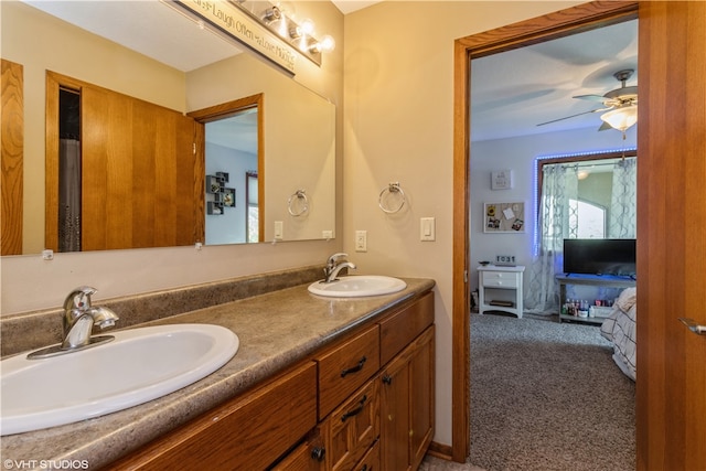 bathroom with large vanity, double sink, and ceiling fan