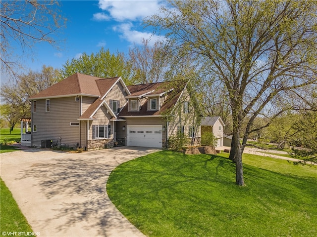 view of front of home with central AC, a front yard, and a garage