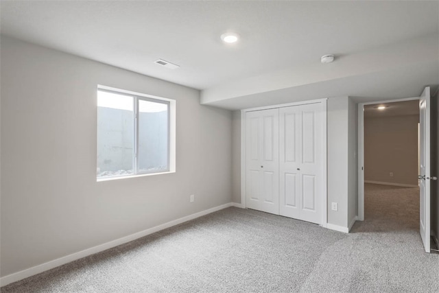 unfurnished bedroom featuring a closet and carpet