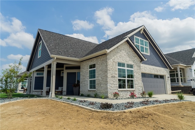 view of side of home with a garage and covered porch