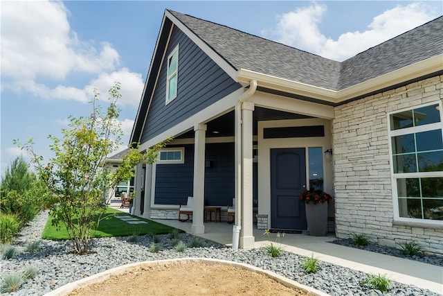 view of exterior entry with covered porch