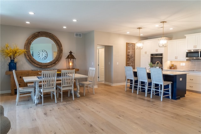 dining room with light hardwood / wood-style flooring