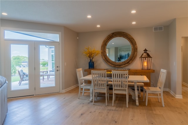 dining area featuring light hardwood / wood-style flooring and french doors