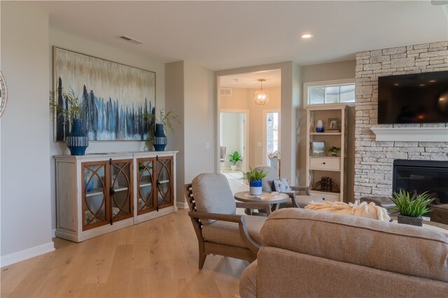 living room with light wood-type flooring and a fireplace