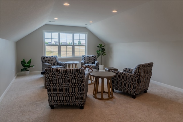 interior space featuring vaulted ceiling and light colored carpet