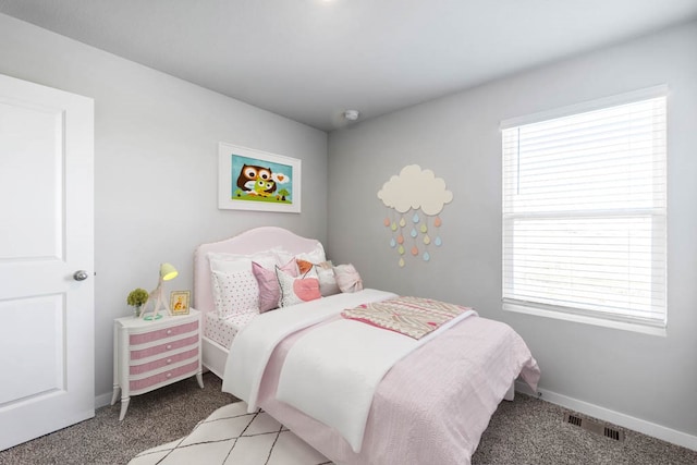 bedroom with light colored carpet and multiple windows