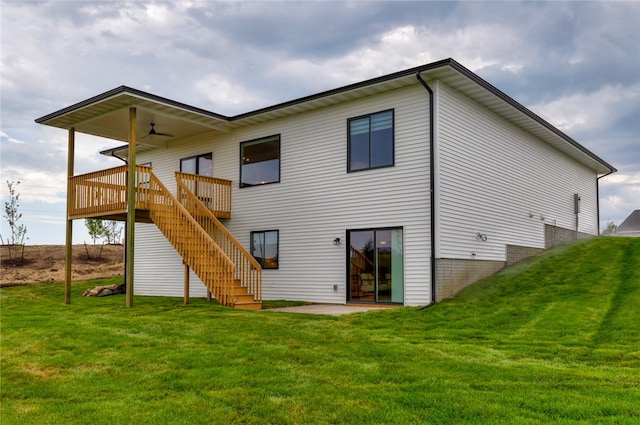 rear view of house featuring ceiling fan, a yard, a patio, and a deck