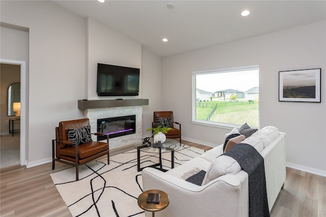 living room featuring light hardwood / wood-style flooring and vaulted ceiling