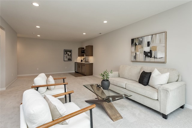 carpeted living room with sink