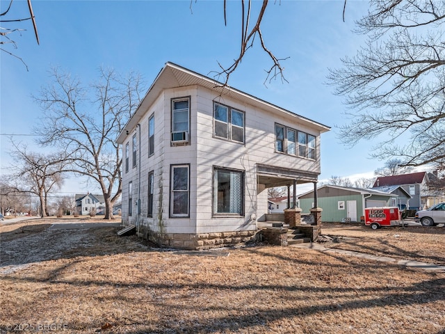 view of front of house with a porch and cooling unit