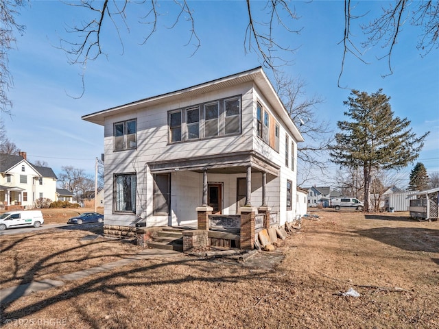 view of front facade with a front yard and covered porch