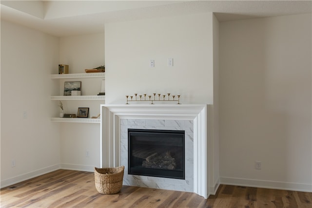 interior space with a high end fireplace and dark wood-type flooring