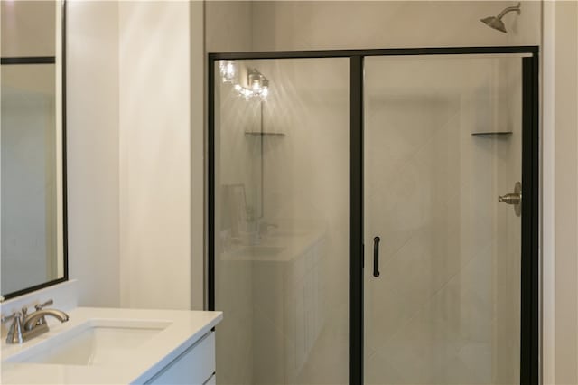 bathroom featuring walk in shower and vanity