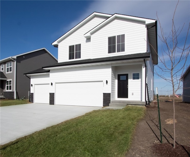 view of front of house with a front yard and a garage