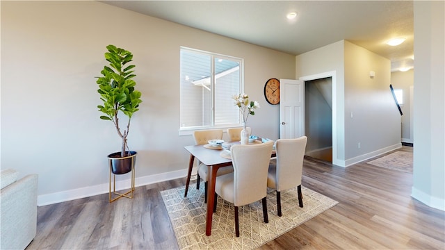 dining room with wood-type flooring