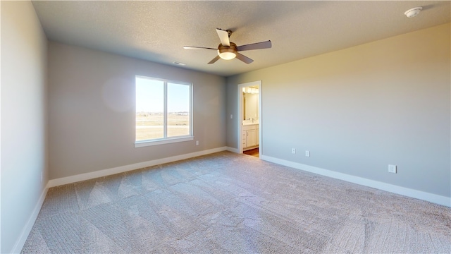 carpeted empty room with a textured ceiling and ceiling fan