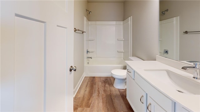 full bathroom featuring vanity, toilet, tub / shower combination, and hardwood / wood-style floors