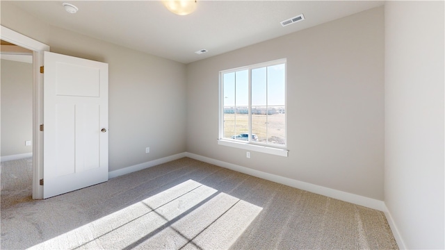 empty room featuring light colored carpet