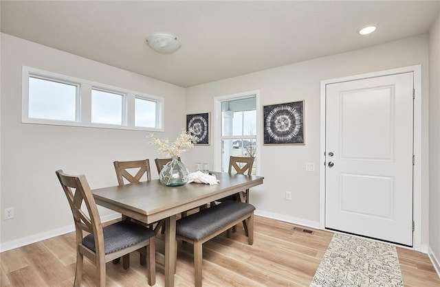 dining space with light hardwood / wood-style floors