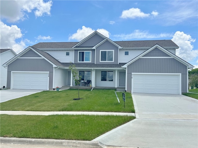 view of front of home featuring a porch, a garage, and a front lawn