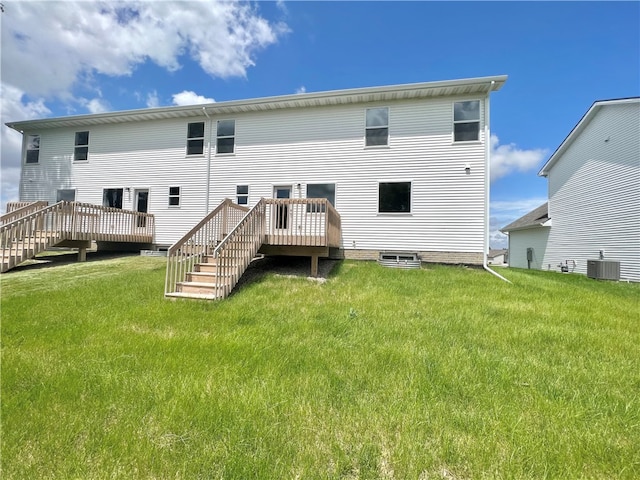 back of house featuring a lawn, a wooden deck, and central AC unit