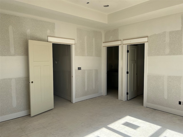 unfurnished bedroom featuring a closet and a walk in closet