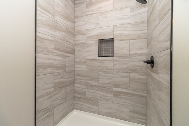 bathroom with tiled shower