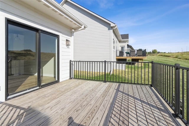 wooden deck featuring a yard