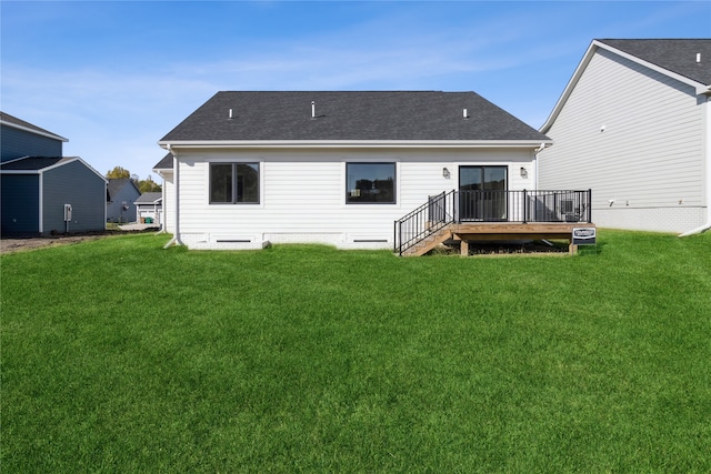 back of property featuring a deck and a yard