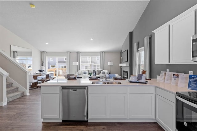 kitchen featuring stainless steel appliances, white cabinetry, and sink