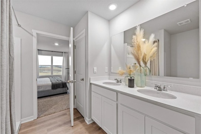 bathroom with vanity and hardwood / wood-style floors