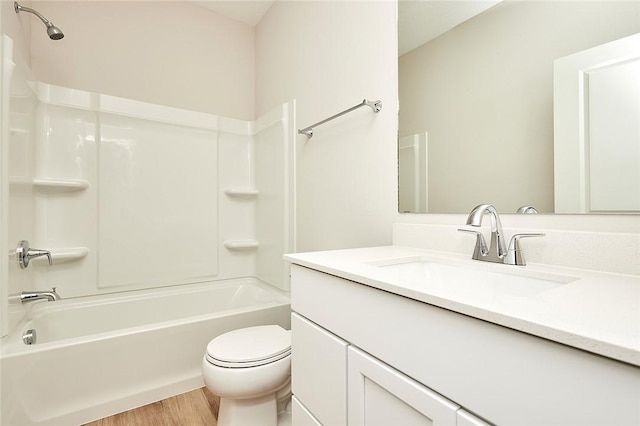 full bathroom featuring vanity, wood-type flooring,  shower combination, and toilet