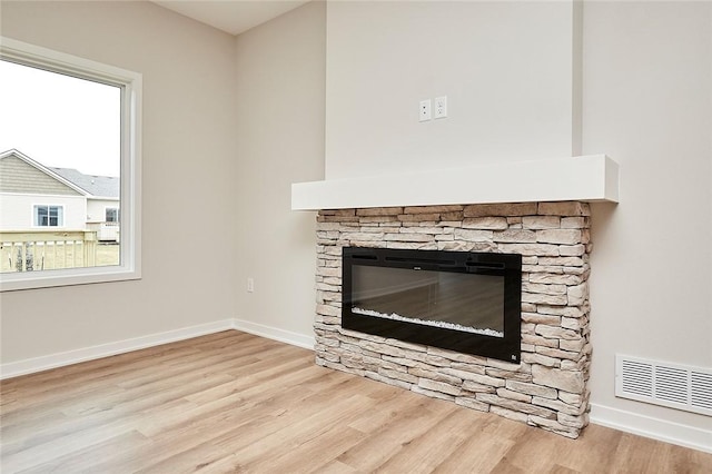 interior details featuring a fireplace and hardwood / wood-style flooring