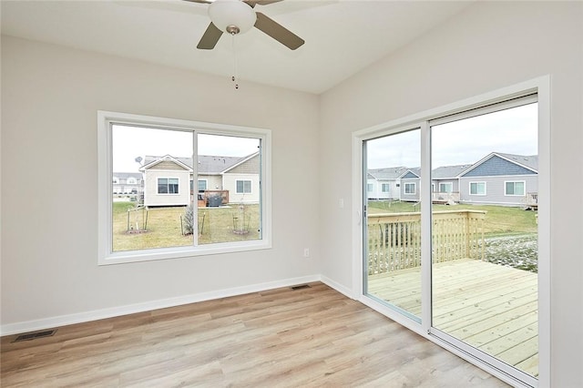 unfurnished room featuring light hardwood / wood-style flooring, a wealth of natural light, and ceiling fan