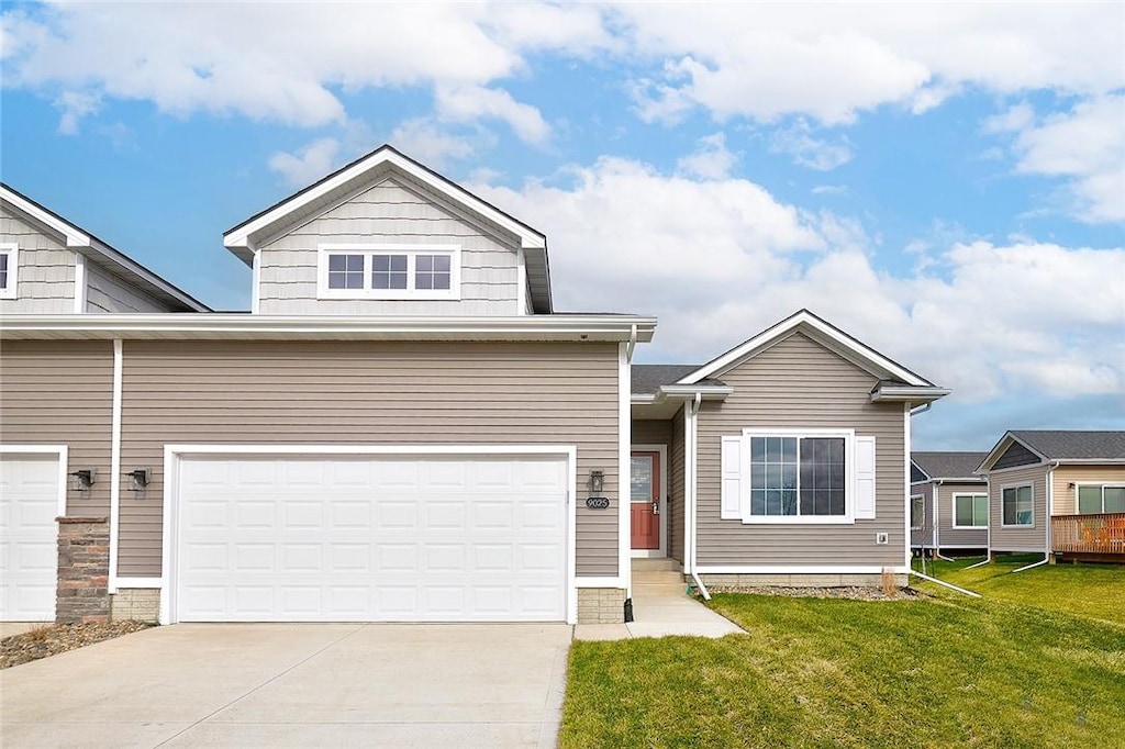 view of front of house featuring a garage and a front lawn