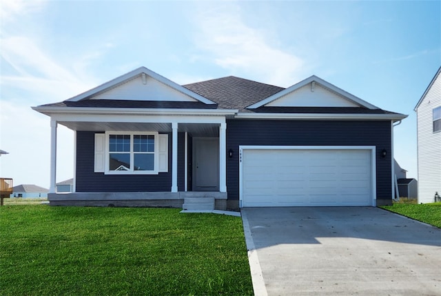 view of front of property featuring a front lawn and a garage