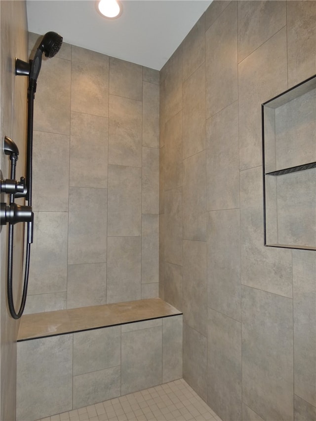 bathroom with tiled shower