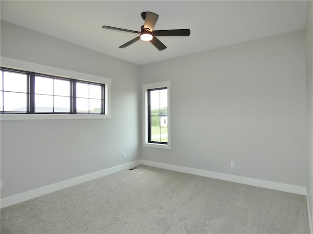 carpeted empty room featuring ceiling fan