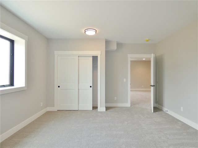 unfurnished bedroom with light carpet