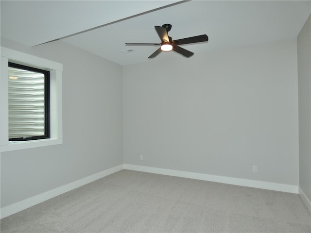 empty room featuring ceiling fan and carpet