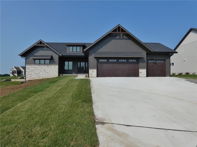 view of front of house featuring a garage and a front lawn