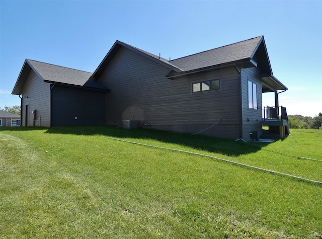 view of property exterior with a yard and central AC