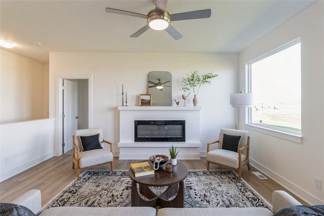 living room featuring hardwood / wood-style flooring and ceiling fan