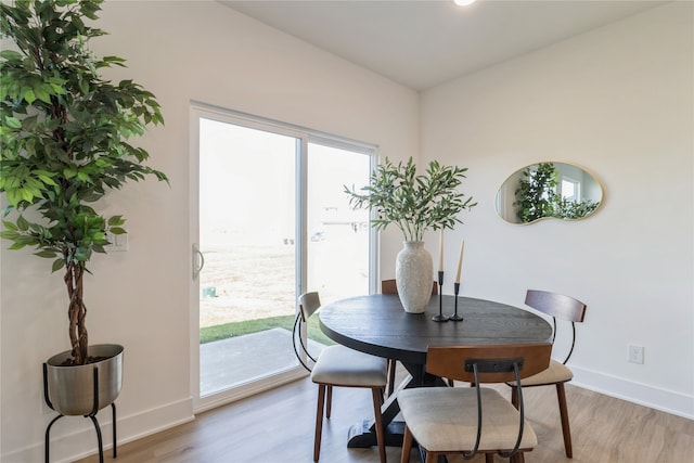 dining area with light hardwood / wood-style floors